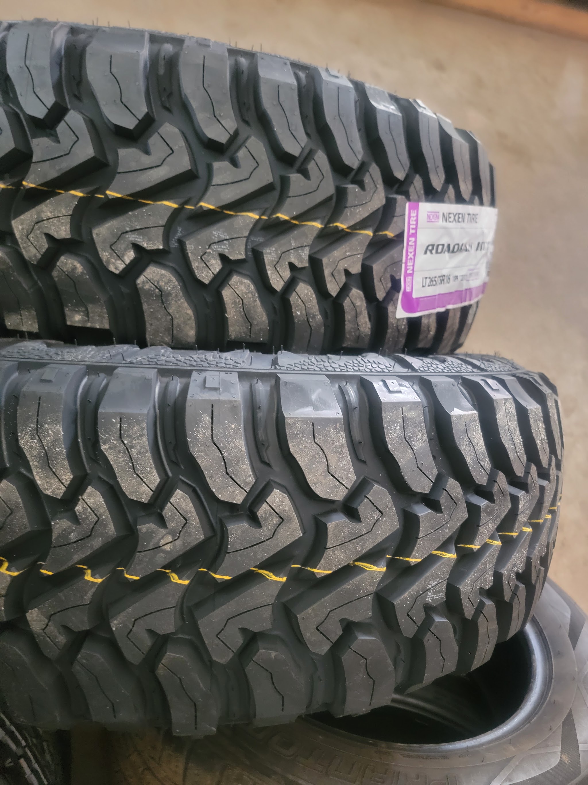 Two new off-road tires with their labels still on